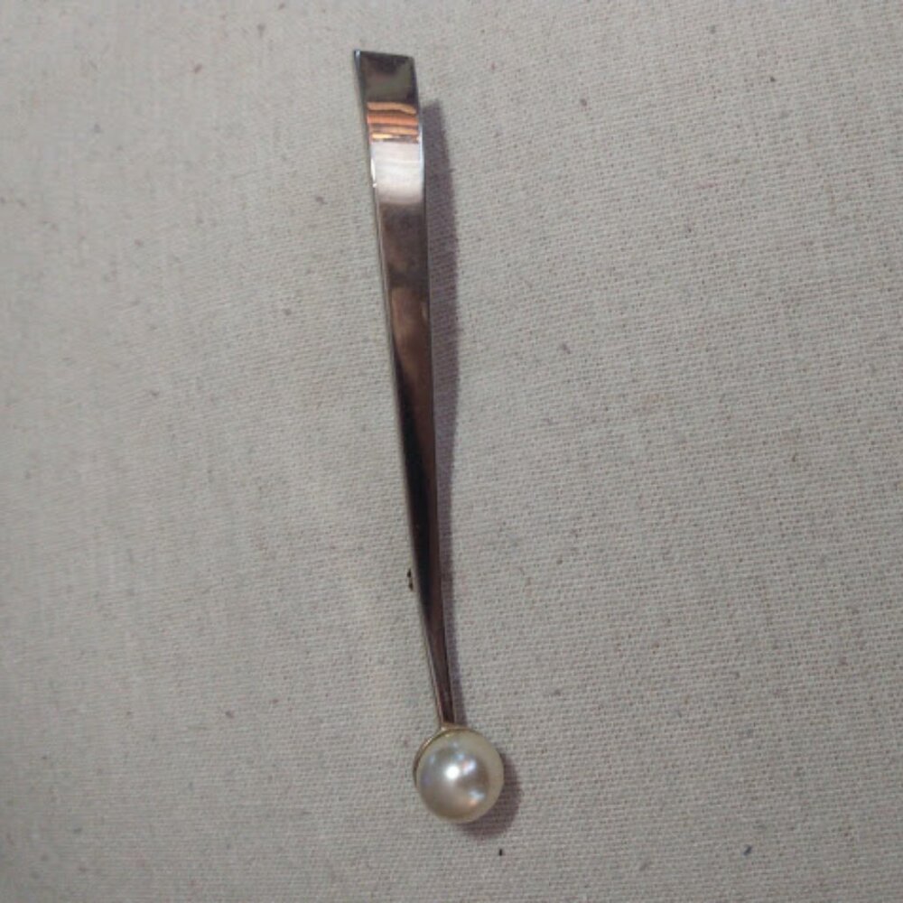 Vintage gold tone long curved bar and faux pearl brooch.